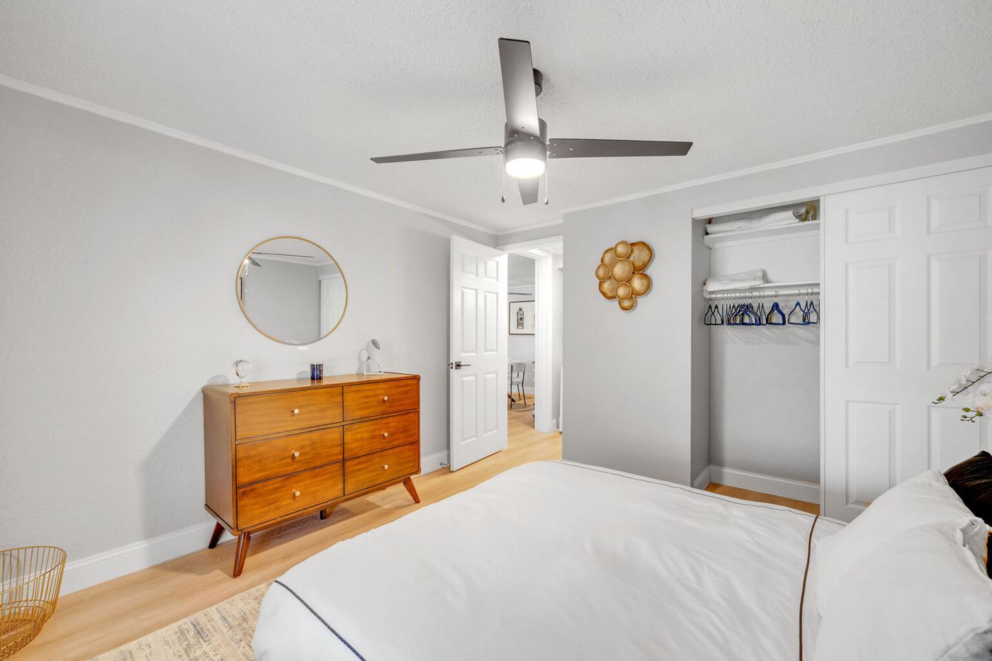 Bedroom with dresser, mirror and closet in a Palm Harbor Villas apartment home