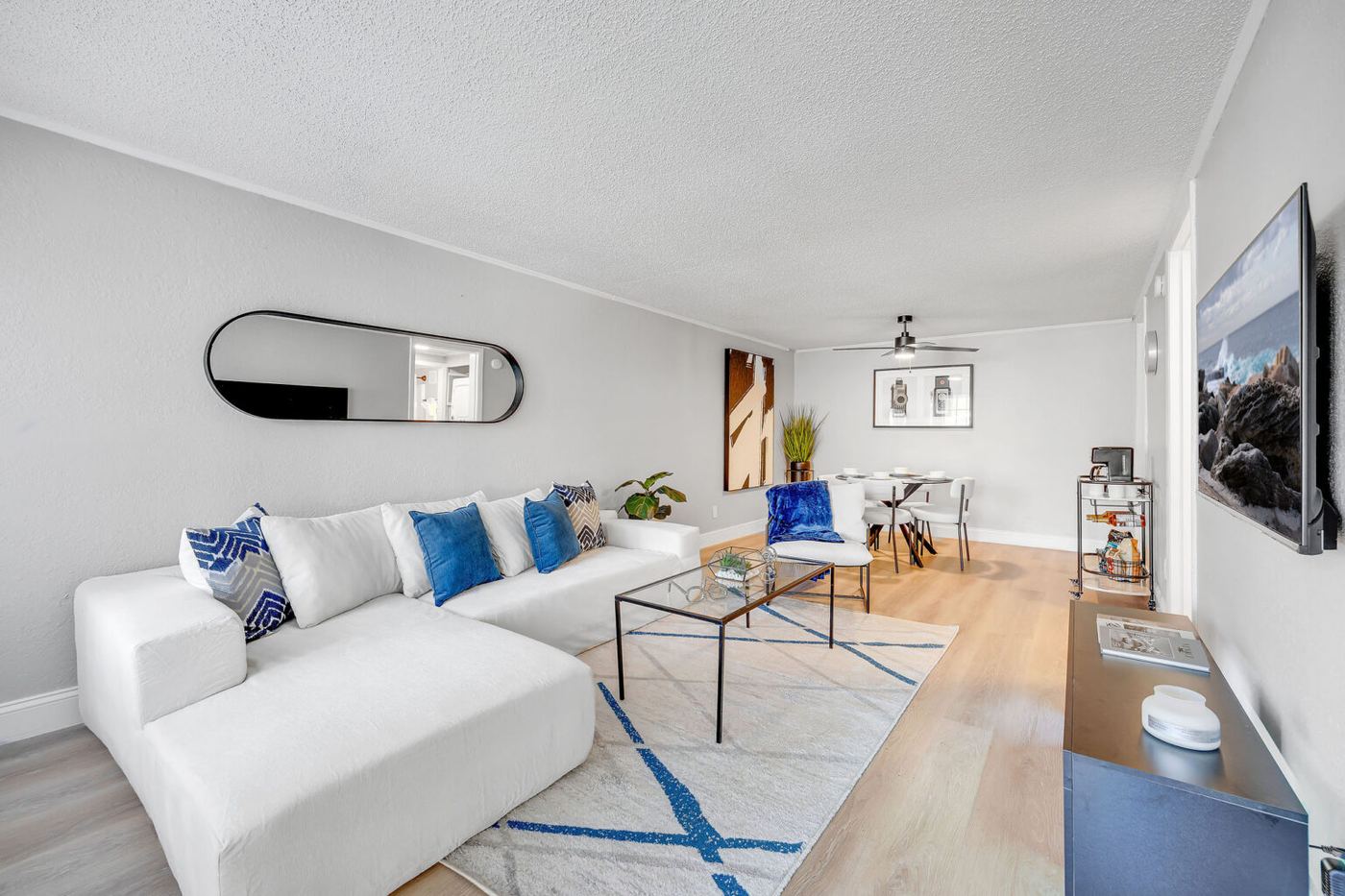 Living room with a sectional sofa in a Palm Harbor Villas apartment home