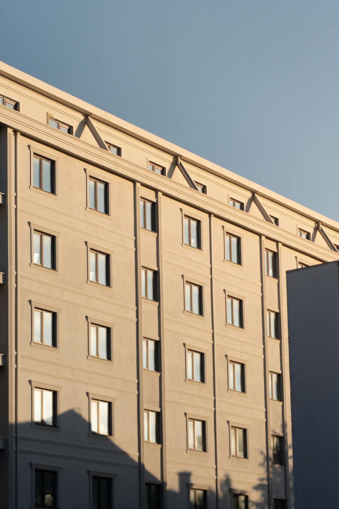 Modern urban building facade captured during golden hour with clear sky